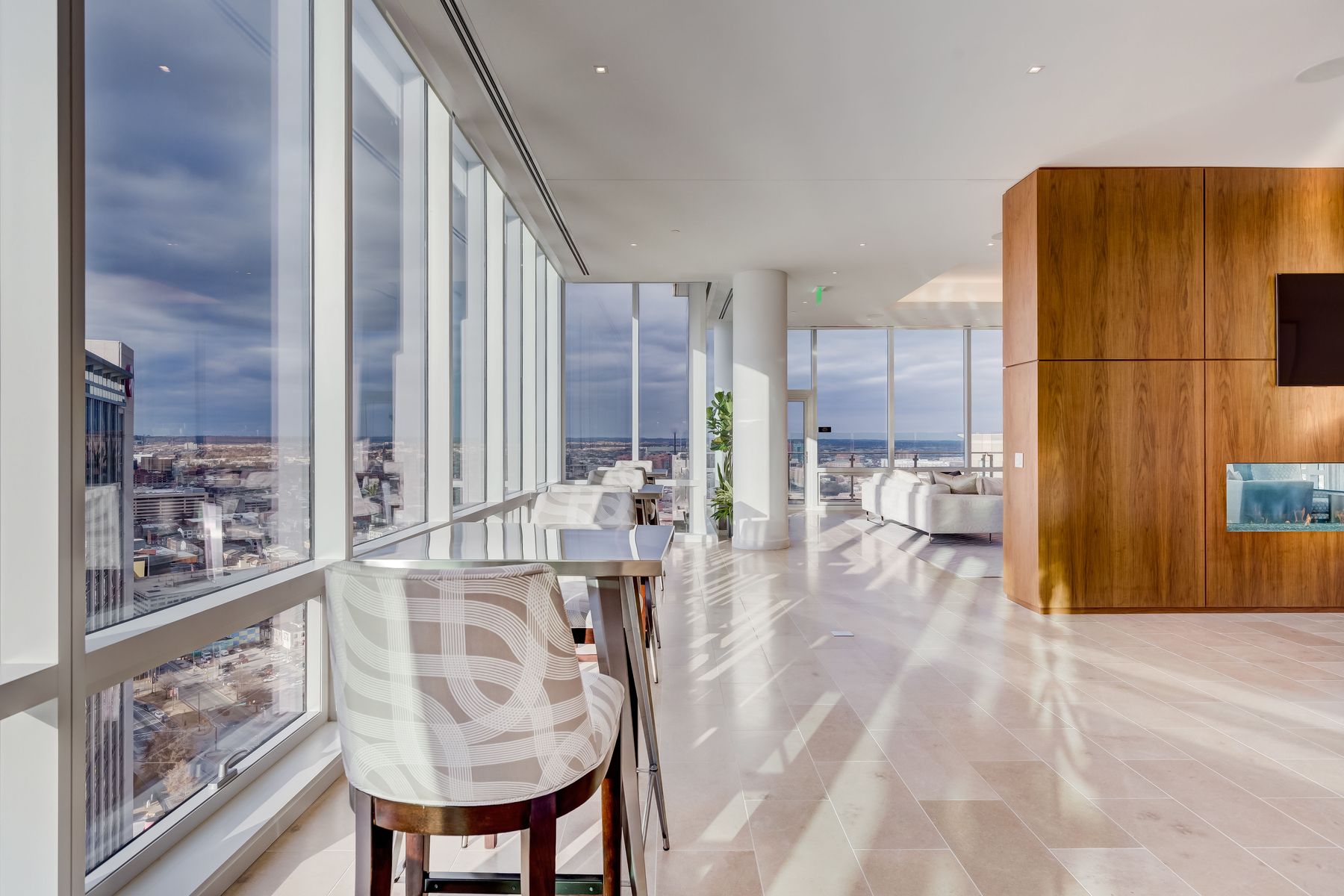 Window-side seating beside a wood-paneled fireplace