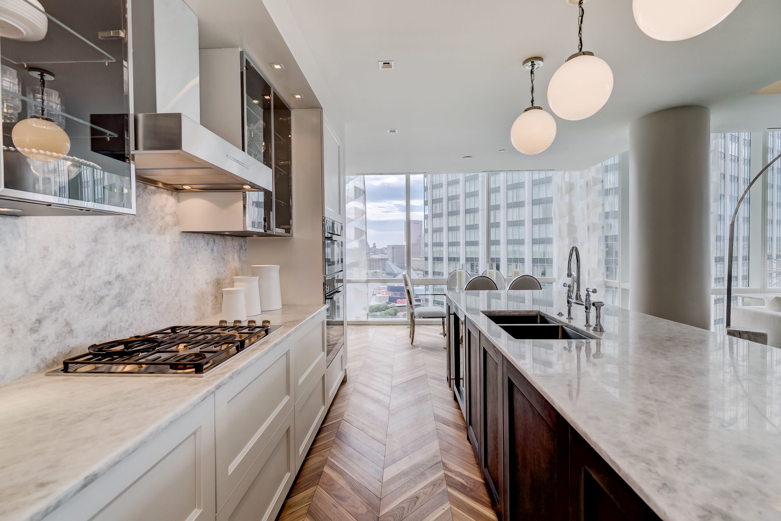 Kitchen cabinetry and marble surfaces looking toward the dining area