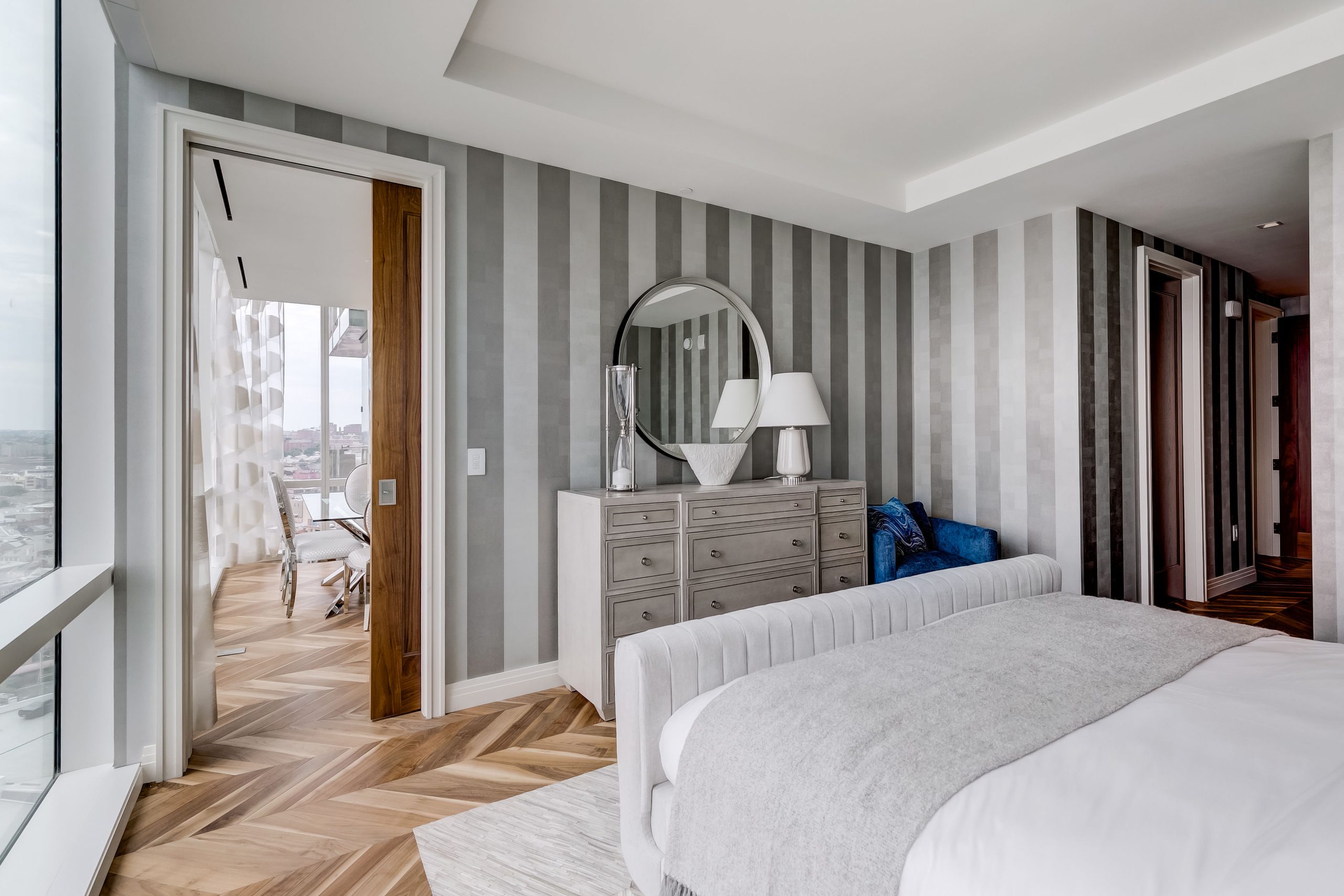 Primary bedroom dresser and round mirror