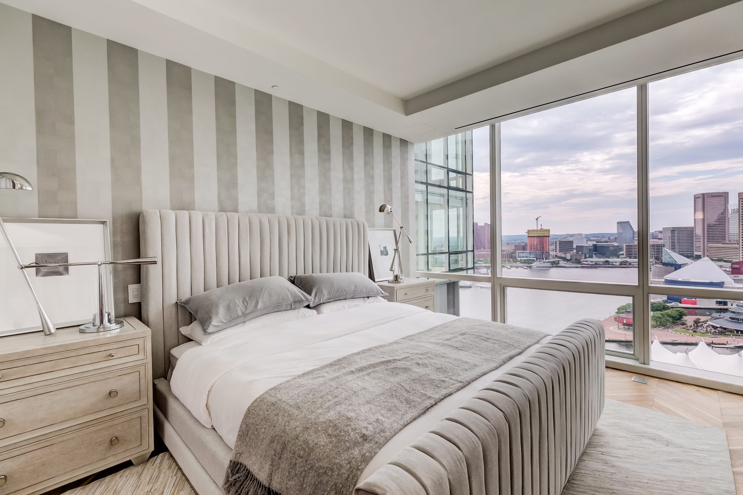 Primary bedroom beside windows overlooking the harbor