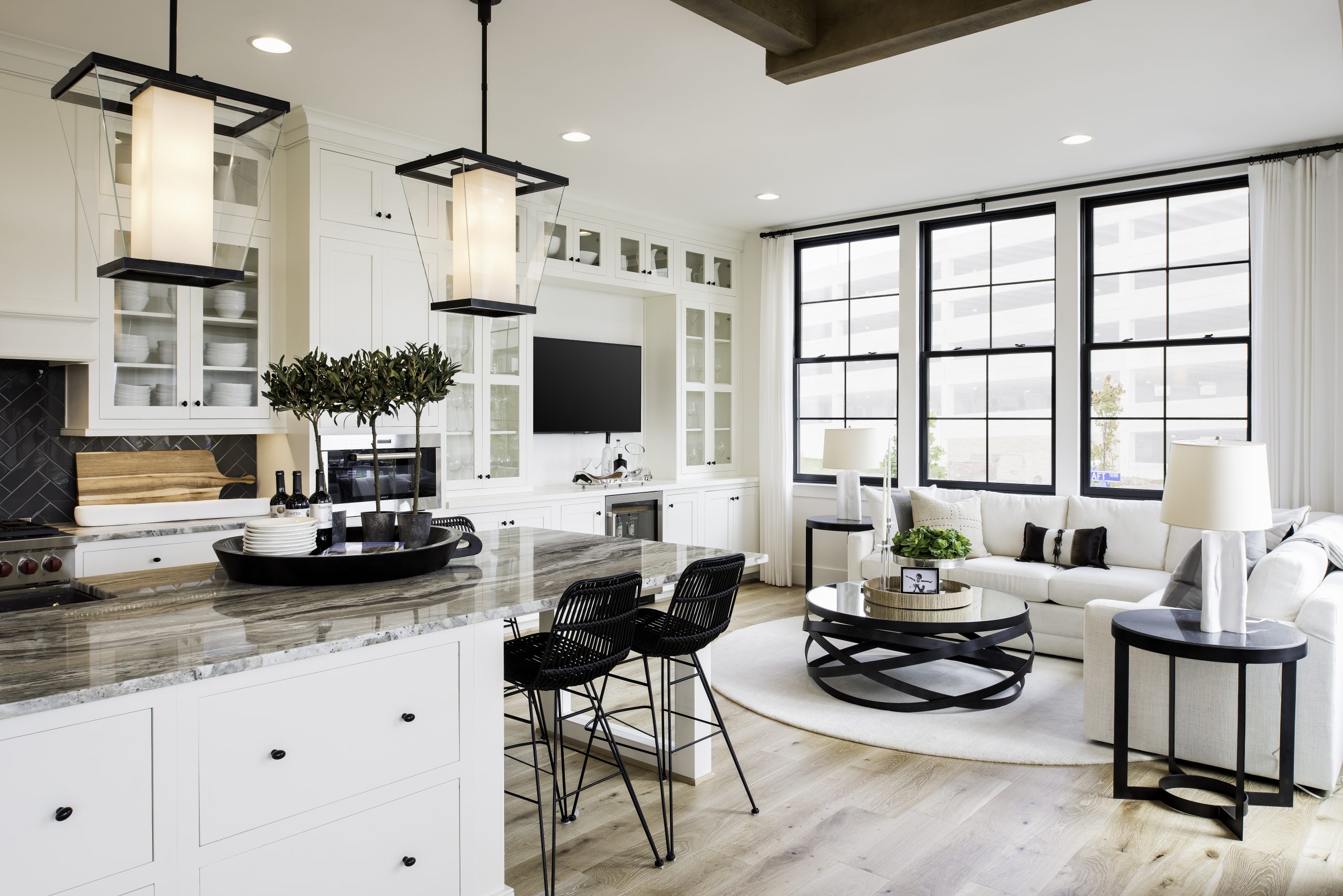 Kitchen island and sitting area beside tall windows
