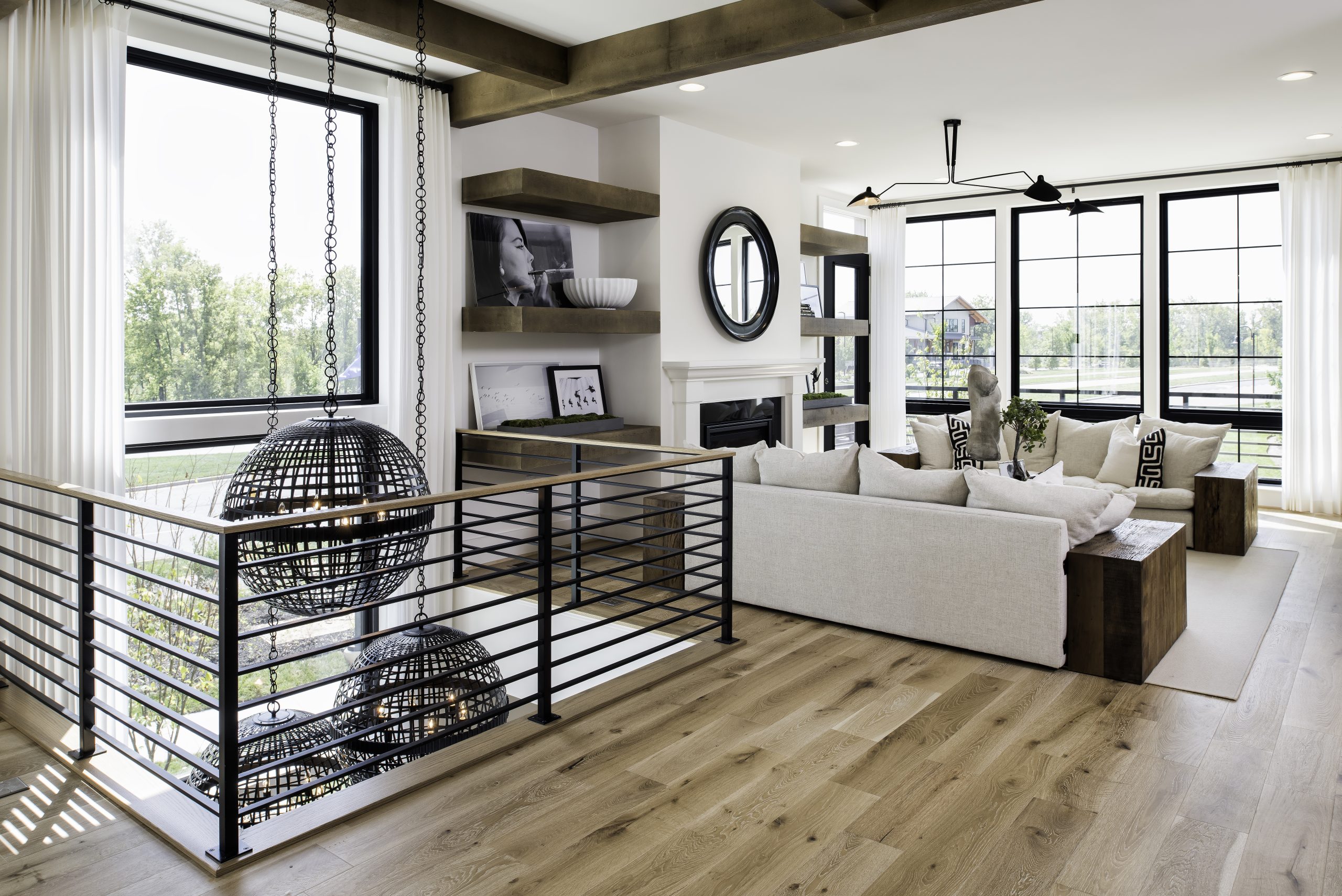 Open living area beside a black metal stair railing