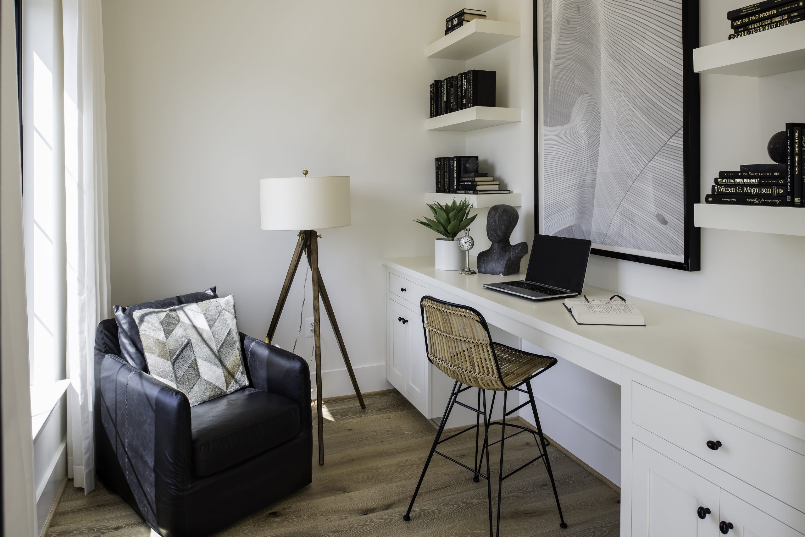 Home office with a built-in desk and upholstered reading chair