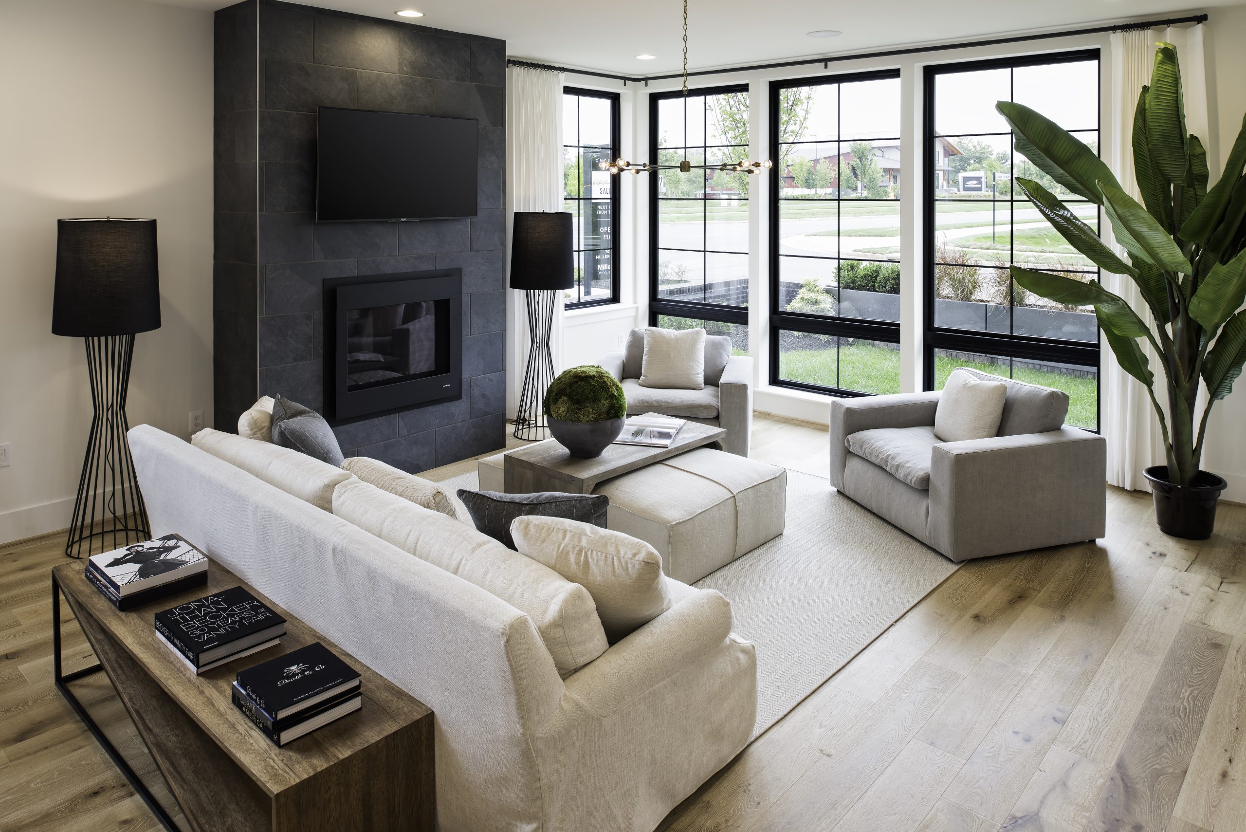 Sitting room with pale upholstered seating and a dark fireplace