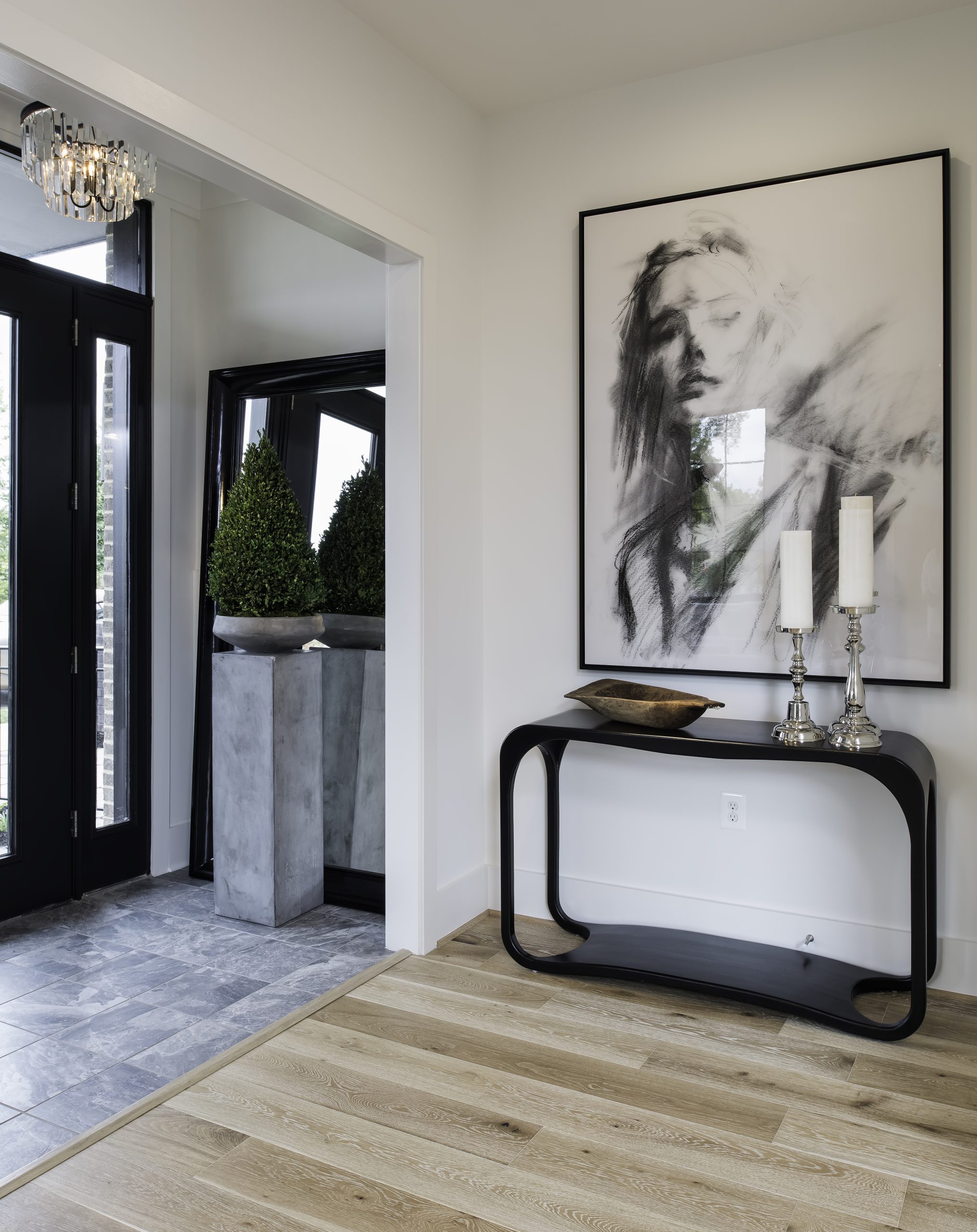 Entry console beneath large framed artwork