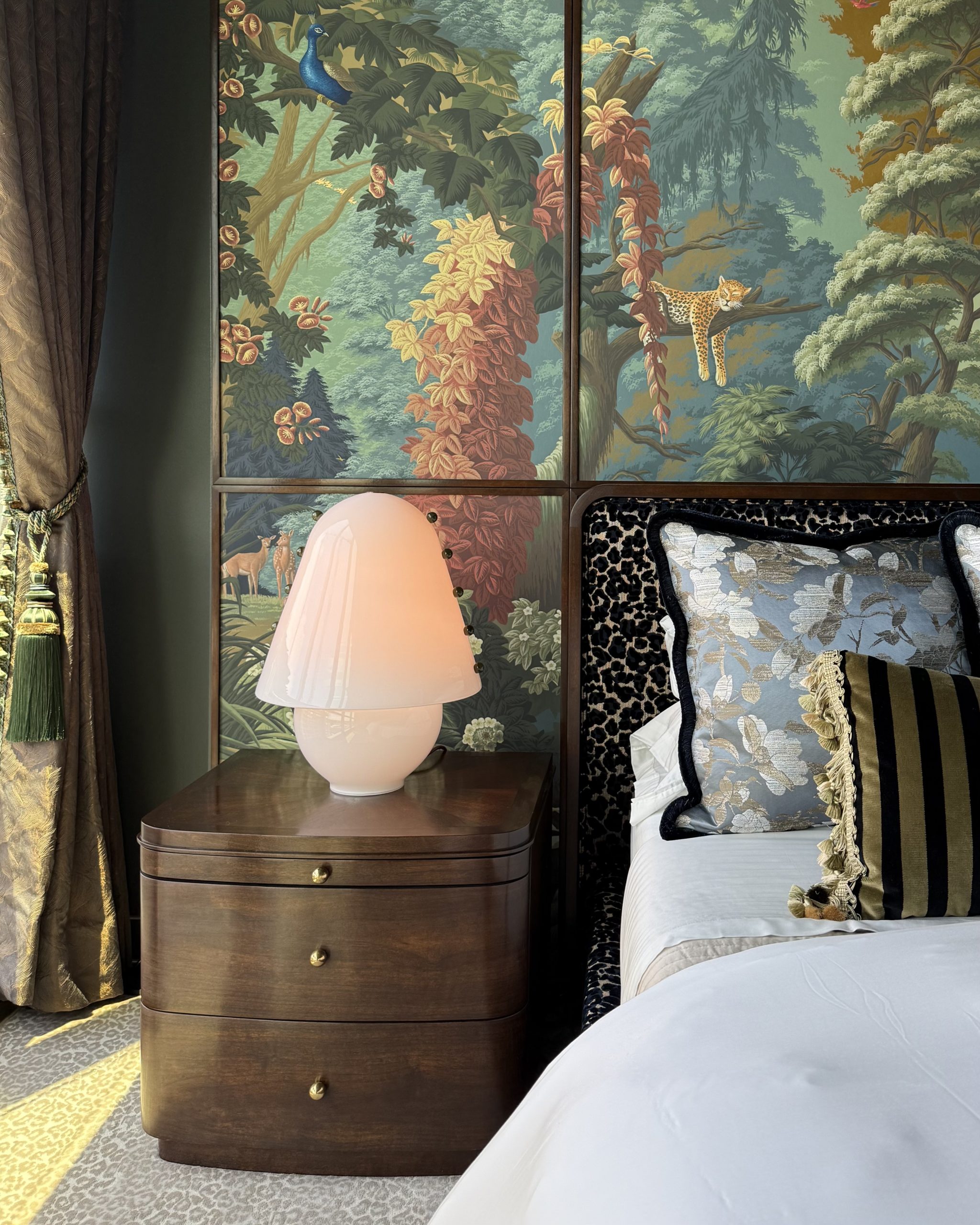 Finished custom nightstand with a pink lamp beside the bed in The Gilded Bower